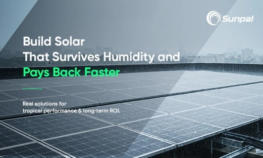 Wide view of a large solar field under cloudy, damp skies.