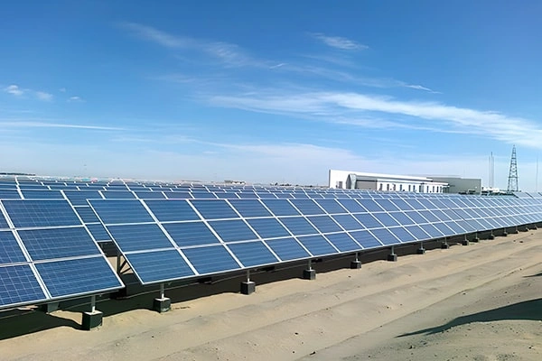 Side distant view of 3MW ground-mounted solar project in South Africa showing PV panel arrangement and concrete foundation structure