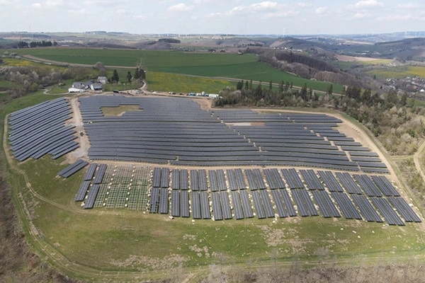 Side distant view of 2MW ground-mounted solar project in Italy showing PV panel arrangement and mounting structure