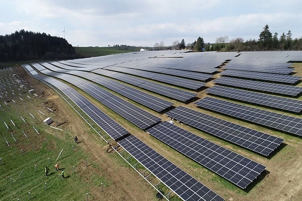 Angled distant view of 2MW ground-mounted solar project in Italy showing overall layout and mounting distribution