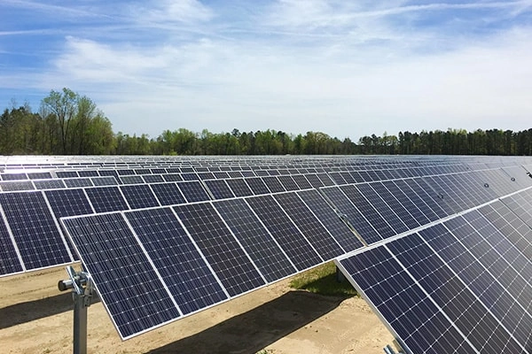 Angled view of 100KW solar system in Zhejiang, China showing overall layout and single-axis tracking mount distribution