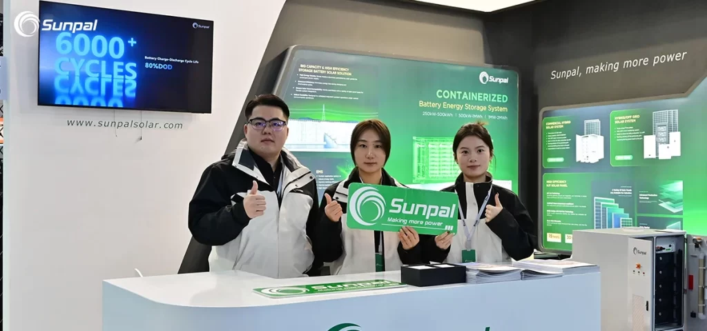 Sunpal booth at Solar Solutions Düsseldorf 2025, three staff members posing with a Sunpal sign in front of green product displays.